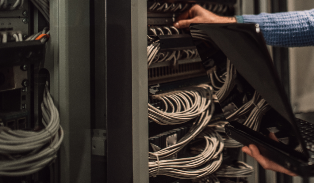 an IT technician assessing computer wiring